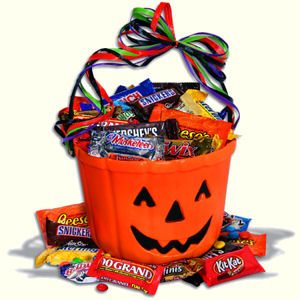 A bright orange ChocOLatern filled with chocolate candy bars for Halloween.