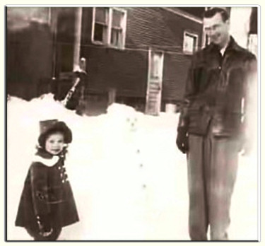 Diane and her loving father by the snowman they built.