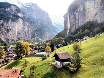 Beautiful mountains, waterfall, valley, and village in Switzerland.