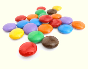 A test sample pile of M&M candies, in various colors, awaits their chance to duel,
and prove which one is best of the bunch.
