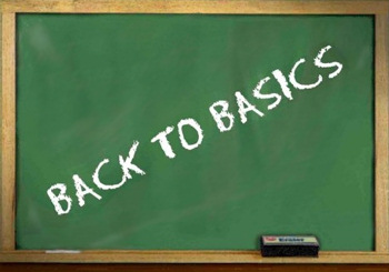 Old green chalk board, that says: Back to basics.