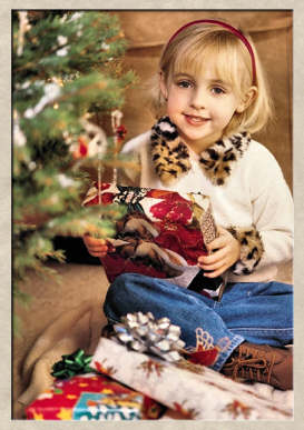 Pretty young girl holding a Christmas present.