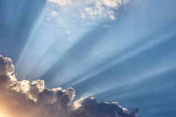 Rays of light through clouds above.