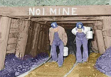 Two bent-over coal miners walking out of the #1 mine.