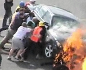 Biker, Under Car, Saved From Fiery Crash By Passersby.