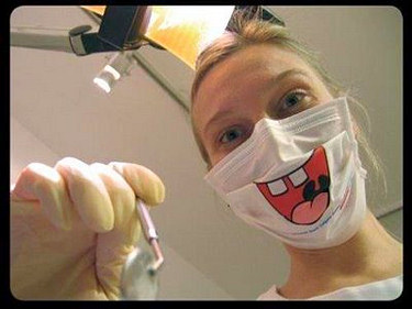 Lady dentist wearing a funny mask.