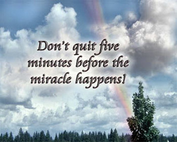 'Don't quit five minutes before the miracle happens' message, on a beautiful nature scene.