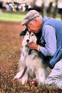 Old man hugging his old dog.