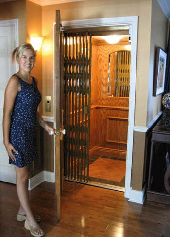 Young woman standing by a home elevator door.