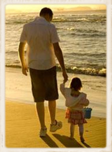 Father and young daughter at the beach.