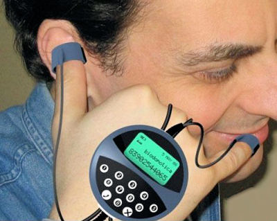 Man with several descreet components on his hand that make-up a phone.