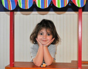 Smiling young girl in a booth.
