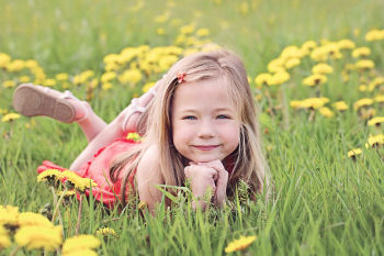 Girl in a field of dandelions