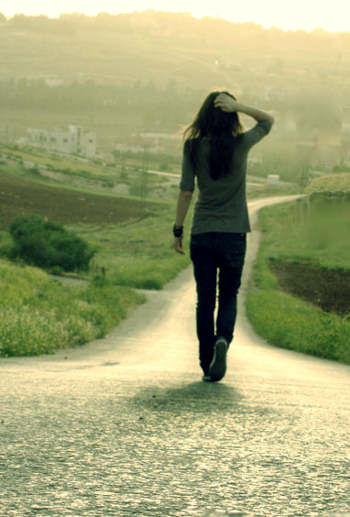 Girl walking down a country road.