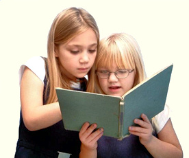 Girl helping her friend with a book.