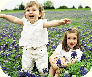 Two young girls - field of Spring flowers.