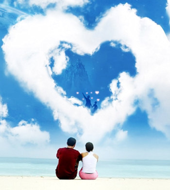 Man and woman sitting on the beach, looking at a Heavenly heart-shapped cloud.
