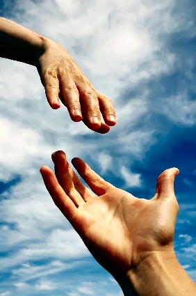 A helping hand reaching out to a hand in need.