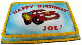 A birthday cake with a car on it for a man who is still young at heart.