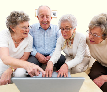 Elderly man and women at a computer - 'keeping in touch'.
