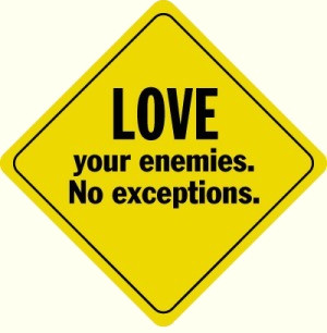 Love your enemies yellow road sign.