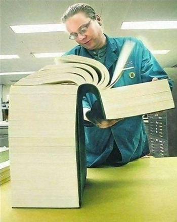 Man looking through a very thick manual - understanding women.