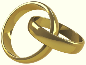 Two gold wedding bands linked together.
