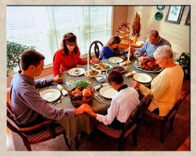 Family giving thanks at the dinner table for God's many blessings.