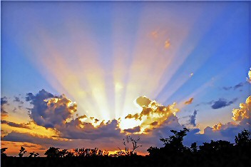 Sunrise rays above a cloud.