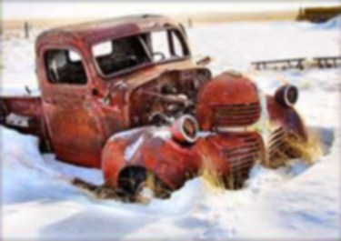 Photo of old rusted red pickup truck, partly buried in the snow.