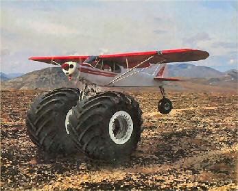 Piper cub like airplane and huge Tundra truck tires.