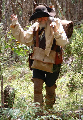 Old woodsmans with his rifle in the outdoors.